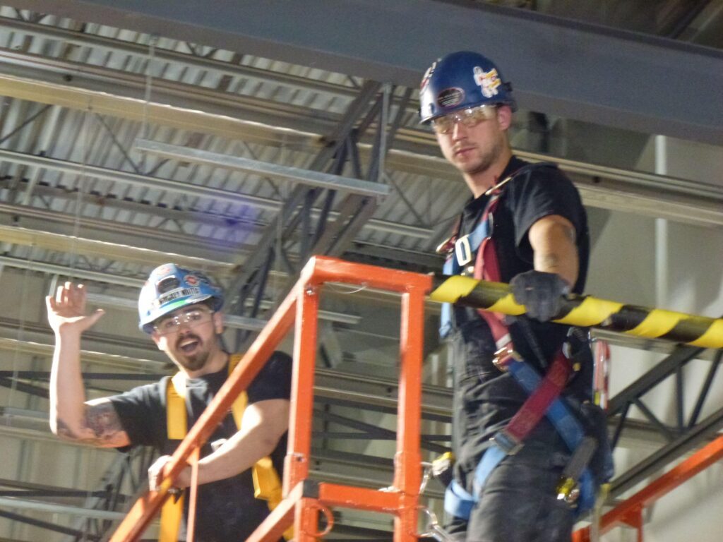 Two Electrician Men Looking at the Camera while Working